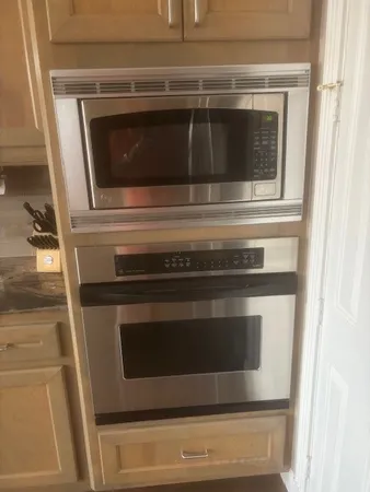 a stove top oven sitting inside of a kitchen