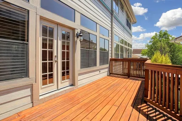 a view of backyard with large trees and wooden floor