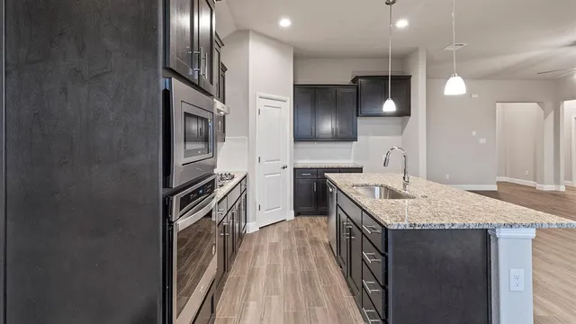 a front view of a house with a garden and plants