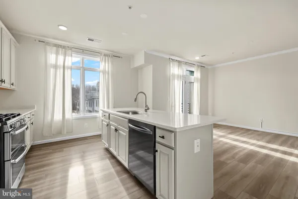 a large kitchen with stainless steel appliances granite countertop a large stove top oven and cabinets