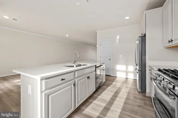 a large white kitchen with a large window