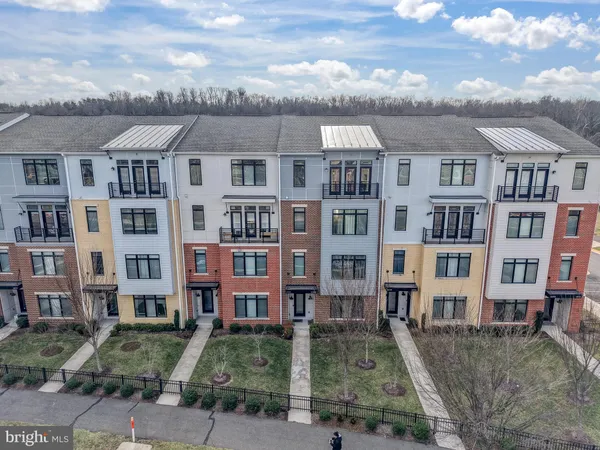 a front view of a residential apartment building with a yard