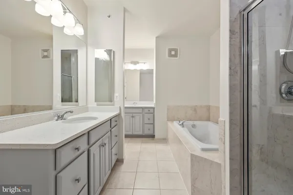 a spacious bathroom with a double vanity sink mirror and double