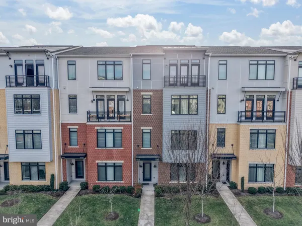a front view of residential apartment building with a yard