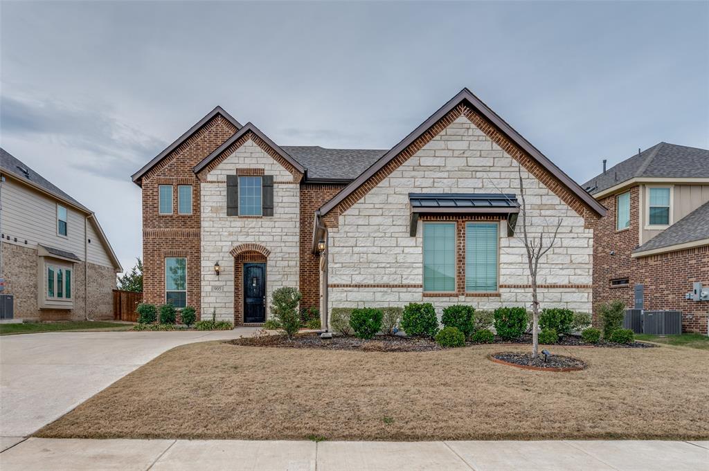 905 Flora Street Mansfield, TX 76063 - Photo 2 of 23 a front view of a house with a yard and garage