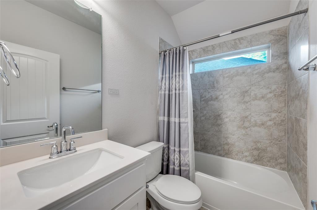 905 Flora Street Mansfield, TX 76063 - Photo 22 of 23 a bathroom with a bathtub shower sink vanity mirror and toilet