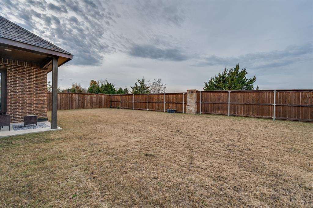 905 Flora Street Mansfield, TX 76063 - Photo 23 of 23 a view of a backyard with a large tree