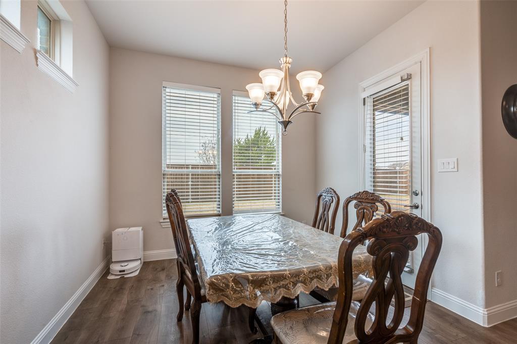 905 Flora Street Mansfield, TX 76063 - Photo 9 of 23 a view of a dining room with furniture wooden floor and chandelier