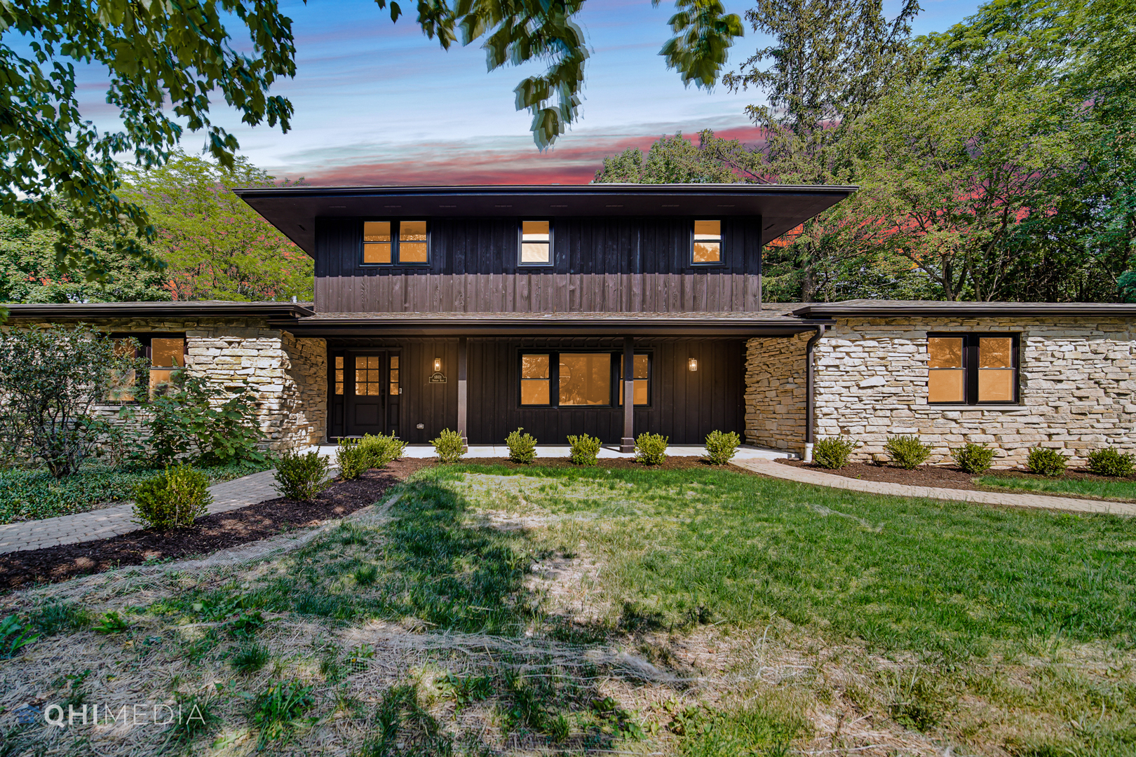 a front view of a house with a yard and porch