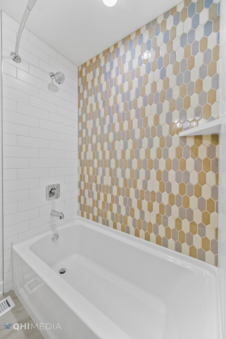 1801 Orchard Road Wheaton, IL 60189 - Photo 25 of 41 a bathroom with a bathtub and shower