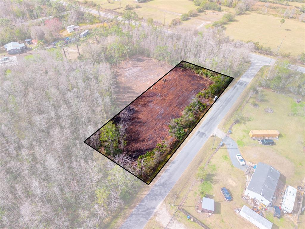 a wooden floor with a bench in backyard