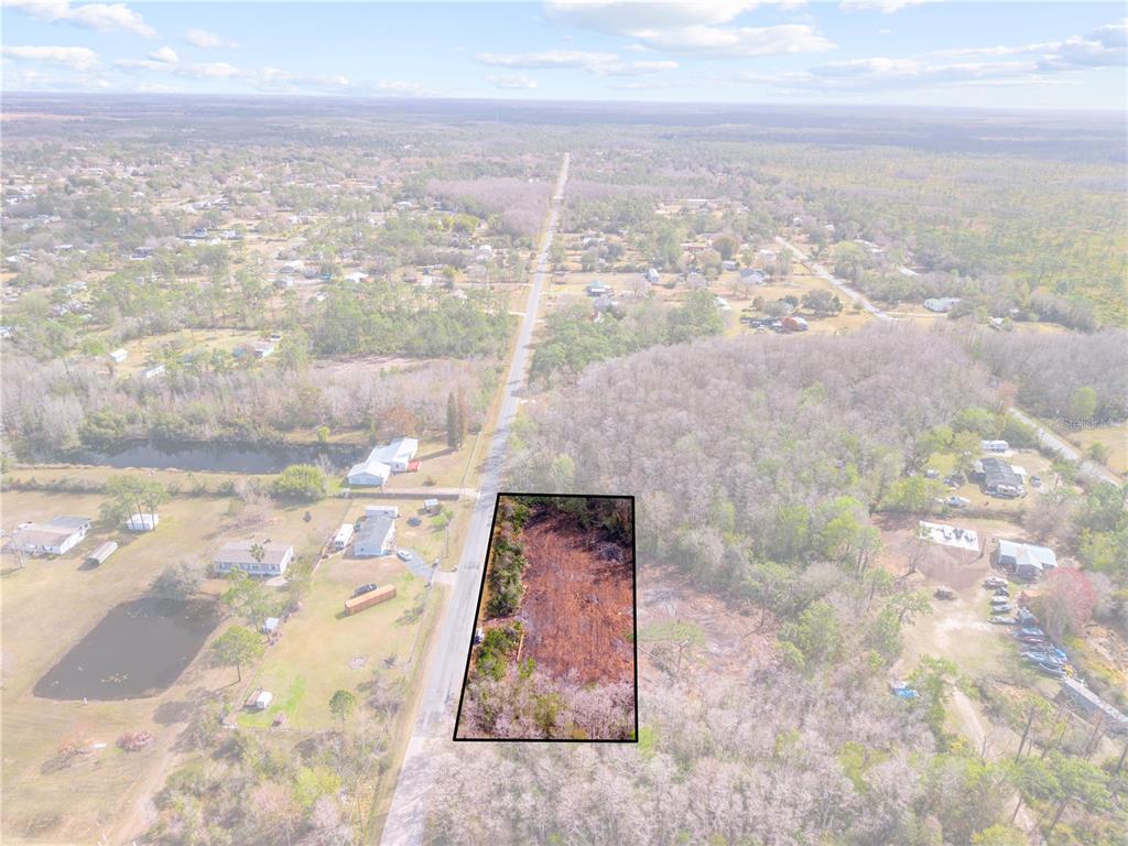 Holopaw Rd Street St. Cloud, FL 34773 - Photo 2 of 18 an aerial view of residential houses with outdoor space