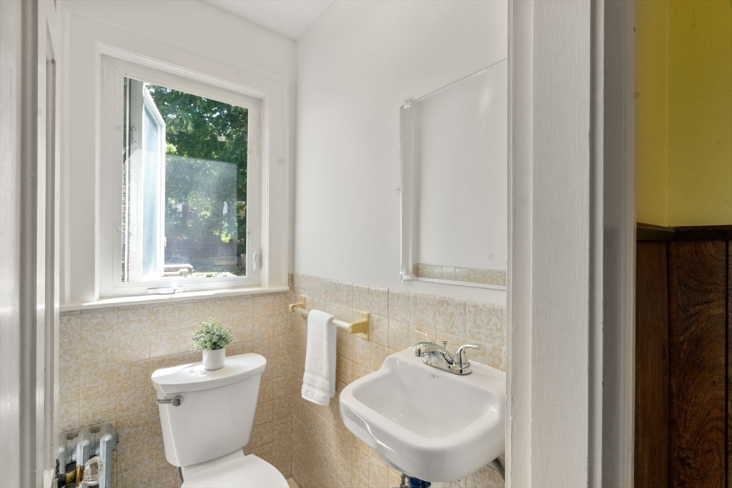 14 Rendall Road Boston, MA 02132 - Photo 7 of 21 a bathroom with a sink a toilet and a mirror