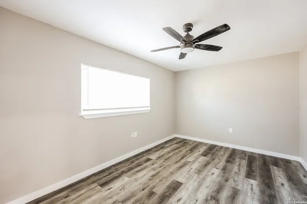 a view of a big room with wooden floor closet and windows