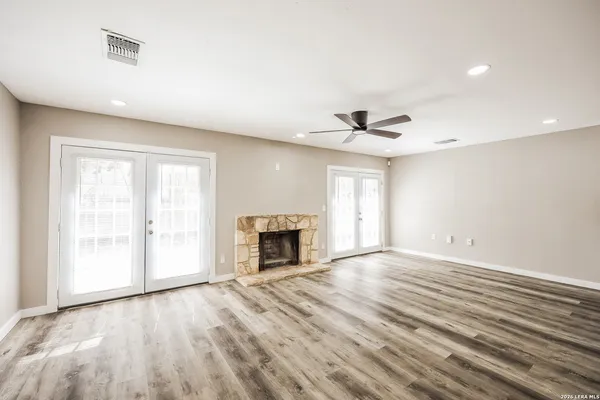 wooden floor in an empty room with a fireplace