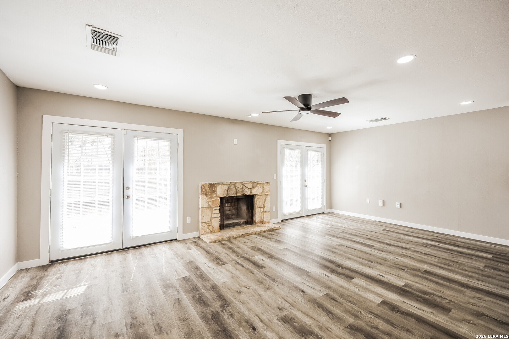 7030 Settlers Ridge Leon Valley, TX 78238 - Photo 6 of 19 wooden floor in an empty room with a fireplace