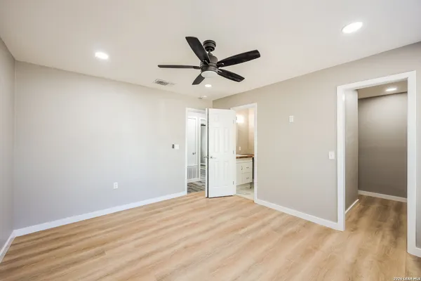 a view of a livingroom with a ceiling fan & a ceiling fan