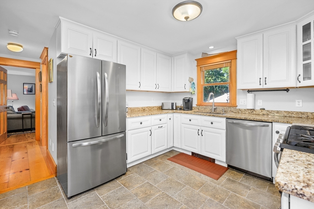 213 Hinckley Road Barnstable, MA 02601 - Photo 13 of 39 a kitchen with granite countertop stainless steel appliances a refrigerator sink and cabinets