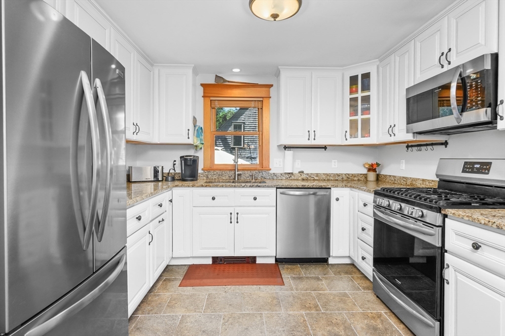 213 Hinckley Road Barnstable, MA 02601 - Photo 14 of 39 a kitchen with stainless steel appliances granite countertop a stove a sink and a refrigerator