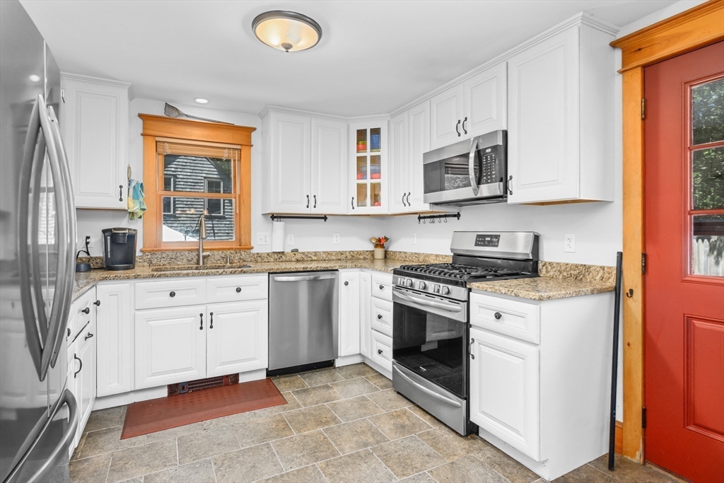 213 Hinckley Road Barnstable, MA 02601 - Photo 15 of 39 a kitchen with stainless steel appliances granite countertop a stove a sink and a microwave