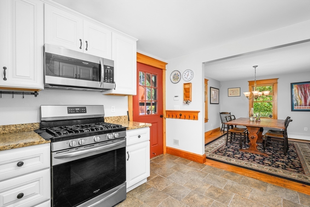 213 Hinckley Road Barnstable, MA 02601 - Photo 16 of 39 a kitchen with stainless steel appliances granite countertop a stove a sink and a microwave