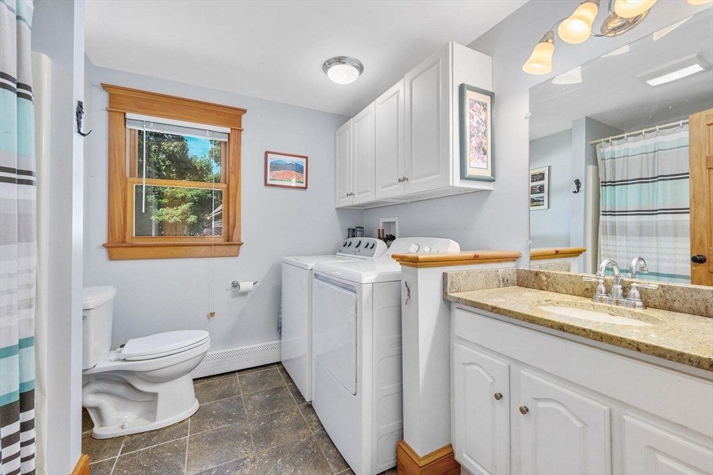 213 Hinckley Road Barnstable, MA 02601 - Photo 17 of 39 a bathroom with a granite countertop toilet sink and mirror