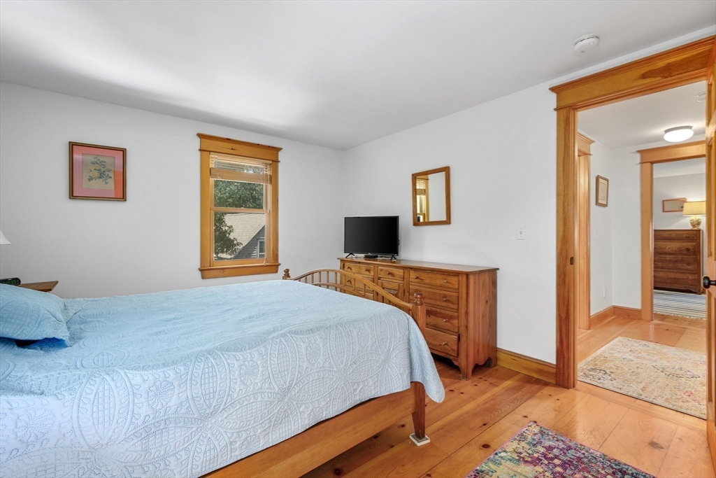 213 Hinckley Road Barnstable, MA 02601 - Photo 23 of 39 a bedroom with a bed and wooden floor