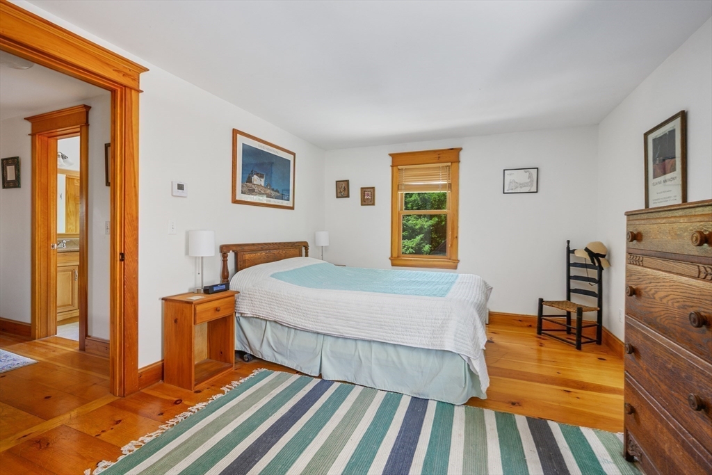 213 Hinckley Road Barnstable, MA 02601 - Photo 25 of 39 a bedroom with a bed and wooden floor
