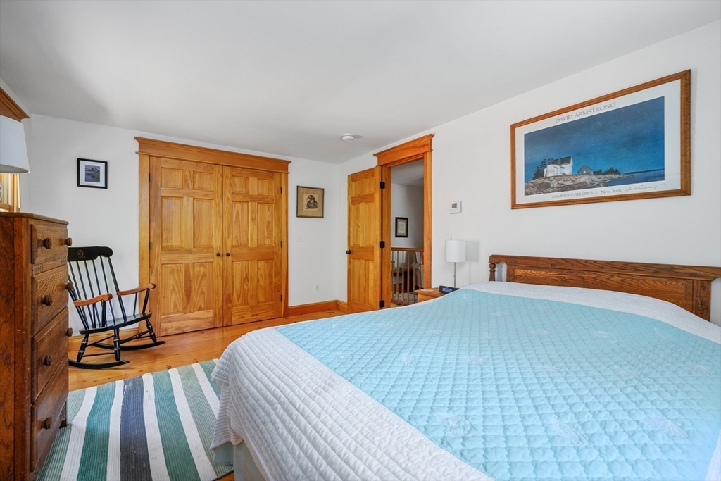 213 Hinckley Road Barnstable, MA 02601 - Photo 26 of 39 a bedroom with a bed and wooden floor