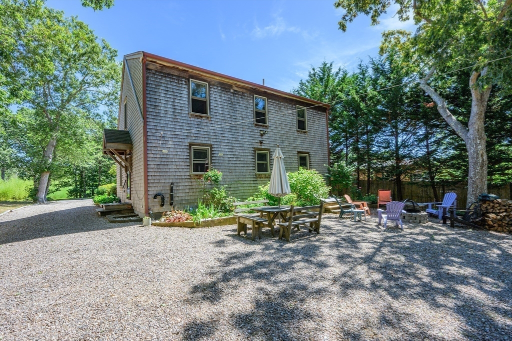 213 Hinckley Road Barnstable, MA 02601 - Photo 28 of 39 a view of a chairs in a backyard