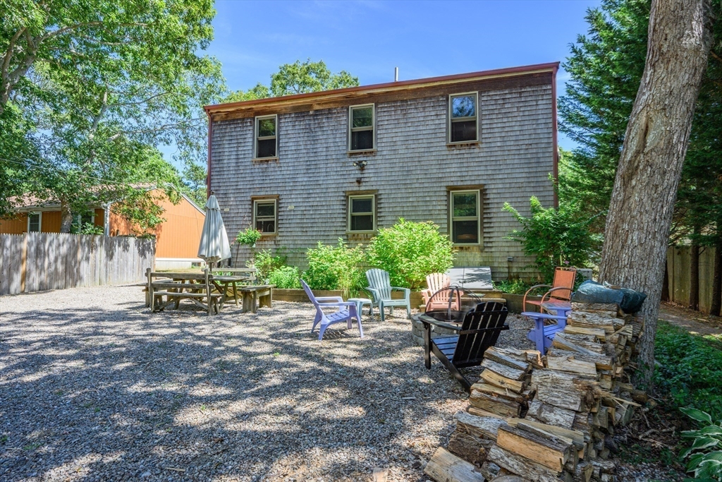 213 Hinckley Road Barnstable, MA 02601 - Photo 29 of 39 a view of a chairs and table in backyard of the house