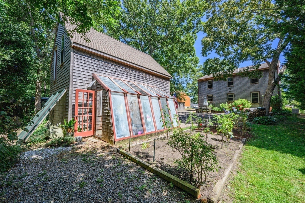 213 Hinckley Road Barnstable, MA 02601 - Photo 33 of 39 a view of a house with backyard and sitting area