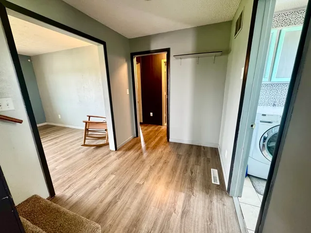 a view of entryway with wooden floor and stairs