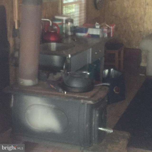 Orchard Road Trappe, MD 21673 - Photo 22 of 28 Interior of hunting cabin - woodstove