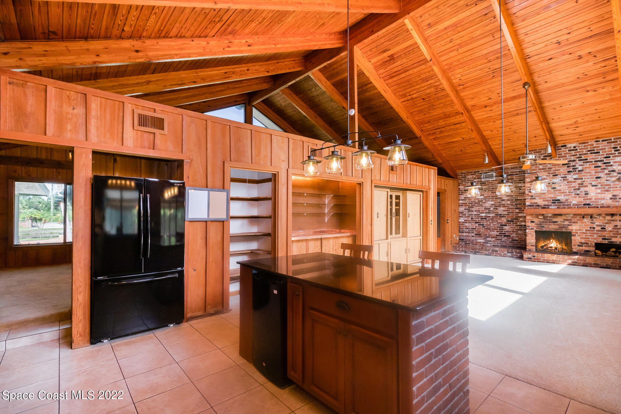 2187 Turtle Mound Road Melbourne, FL 32934 - Photo 13 of 42 a kitchen with stainless steel appliances granite countertop a sink and a refrigerator