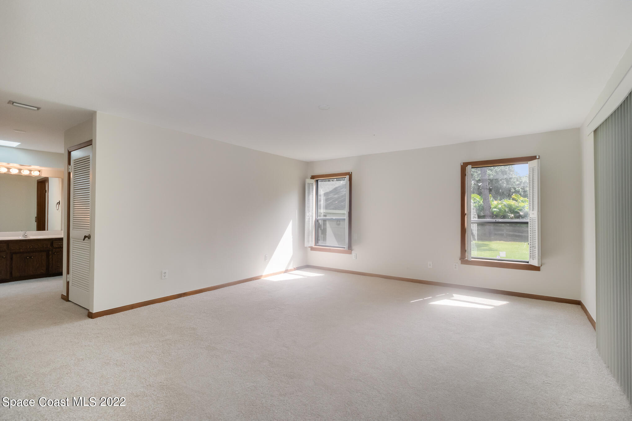 2187 Turtle Mound Road Melbourne, FL 32934 - Photo 18 of 42 an empty room with windows