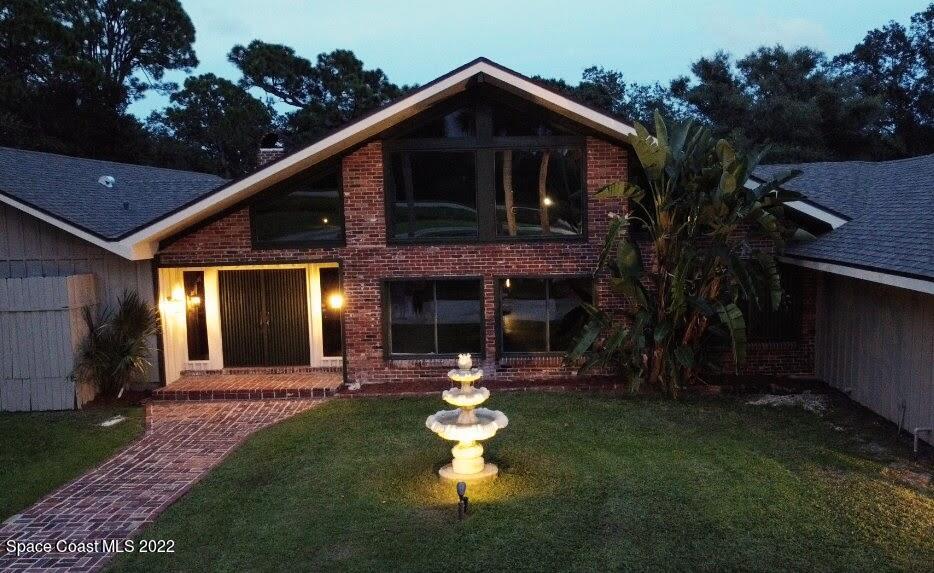 2187 Turtle Mound Road Melbourne, FL 32934 - Photo 2 of 42 a front view of a house with a yard garden and outdoor seating