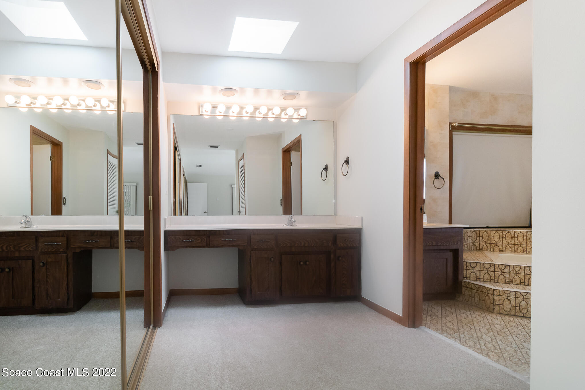 2187 Turtle Mound Road Melbourne, FL 32934 - Photo 21 of 42 a bathroom with a double vanity sink and a mirror