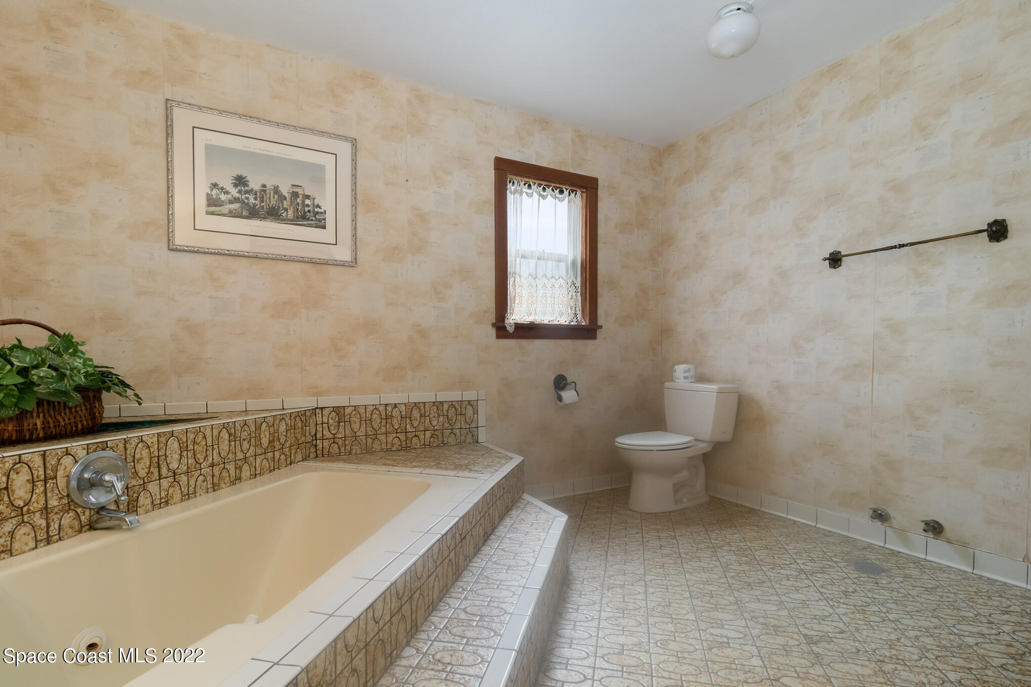2187 Turtle Mound Road Melbourne, FL 32934 - Photo 23 of 42 a bathroom with a tub and toilet
