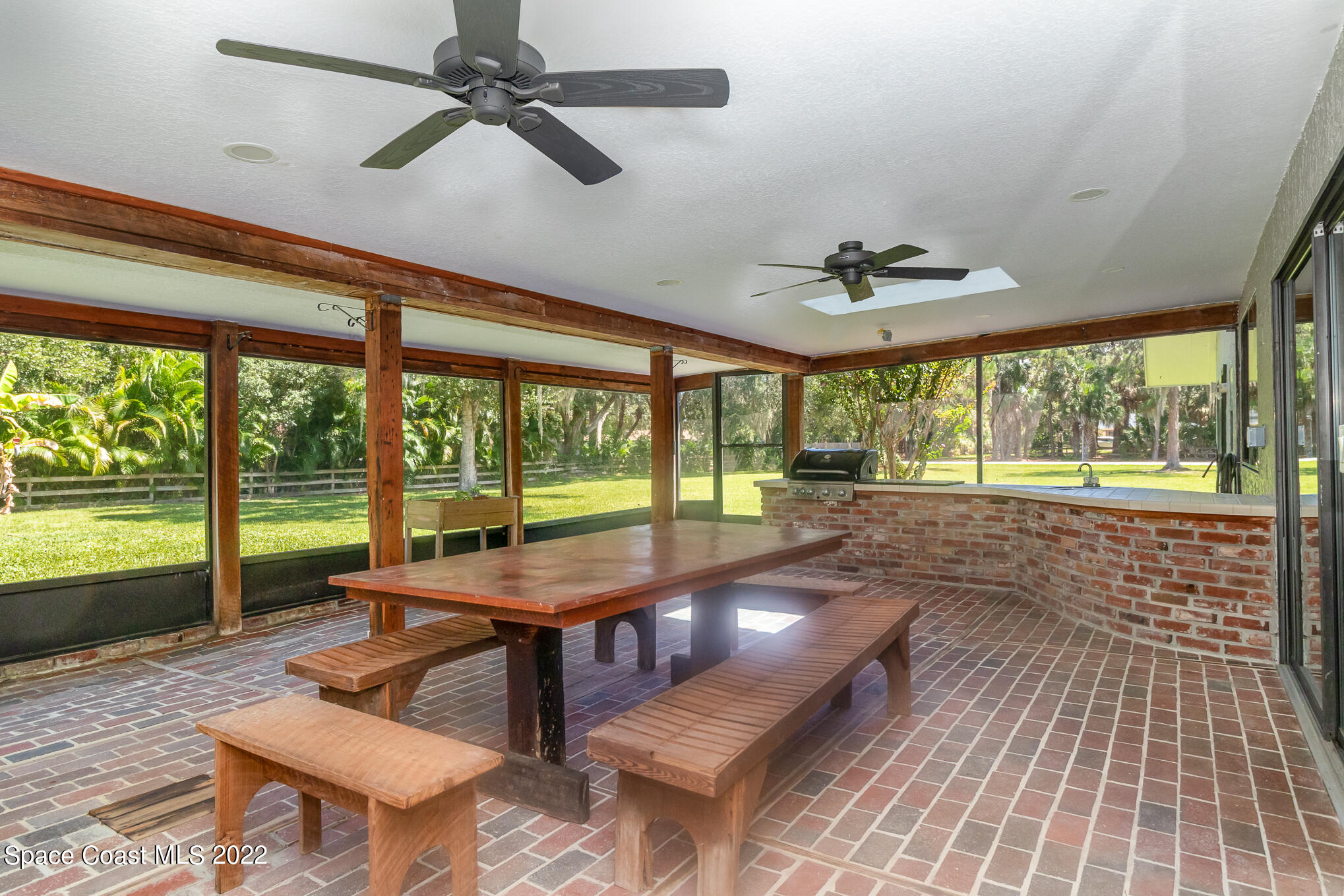 2187 Turtle Mound Road Melbourne, FL 32934 - Photo 33 of 42 a living room with large windows and a table