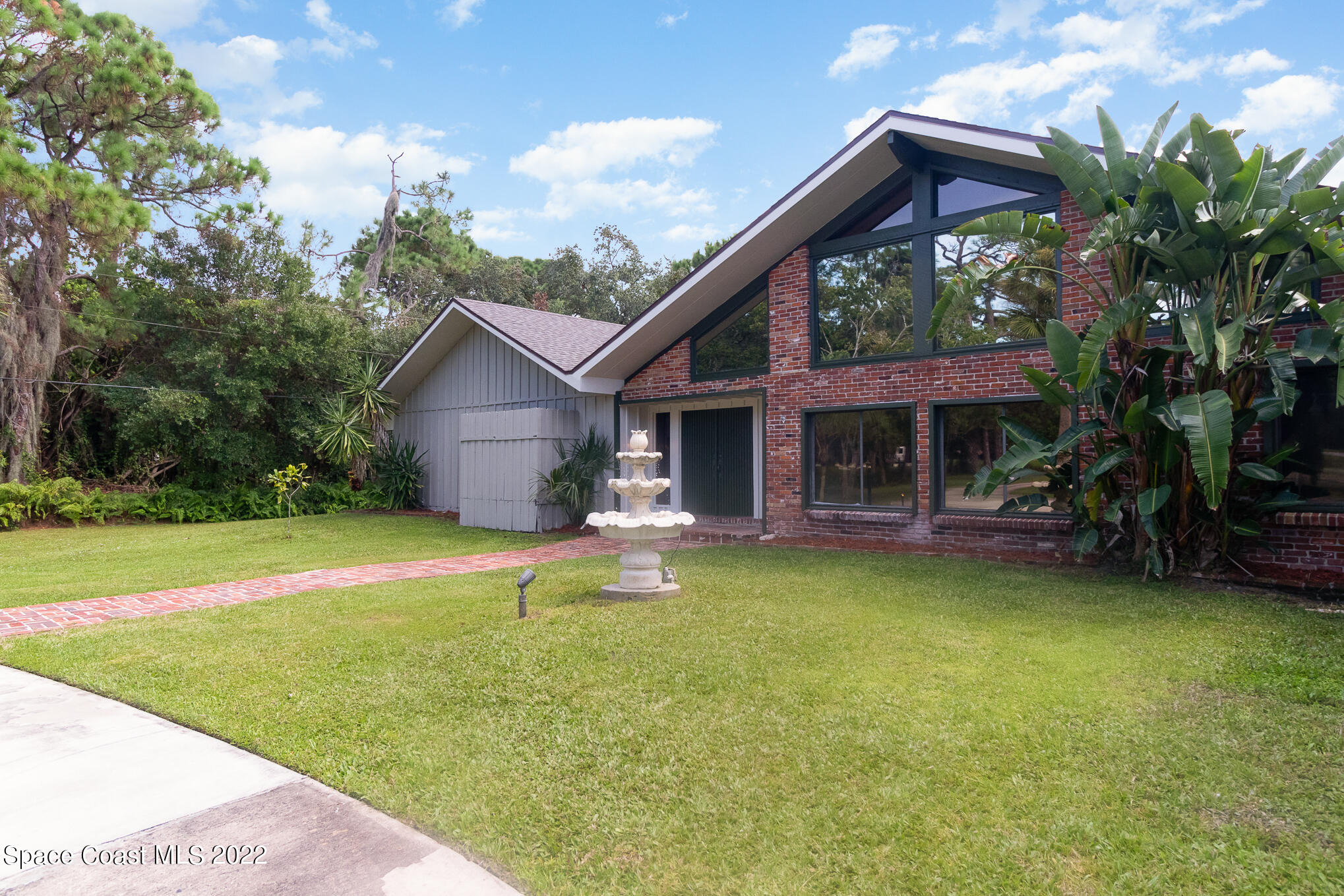 2187 Turtle Mound Road Melbourne, FL 32934 - Photo 4 of 42 a front view of a house with swimming pool having outdoor seating