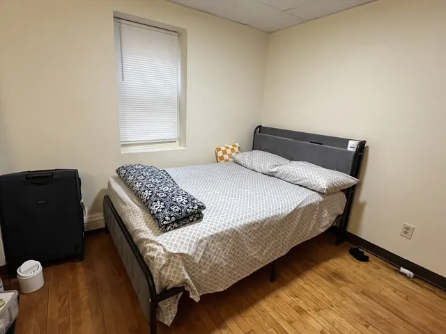 a bedroom with a bed and window