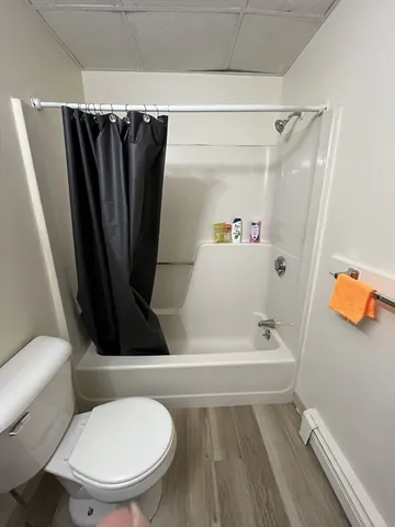 a bathroom with a toilet and a tub