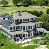 a aerial view of a house with garden and swimming pool