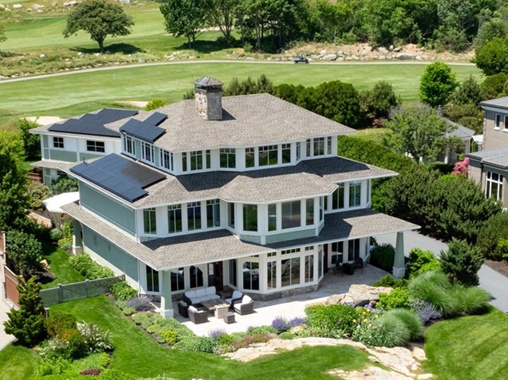 a aerial view of a house with garden and swimming pool