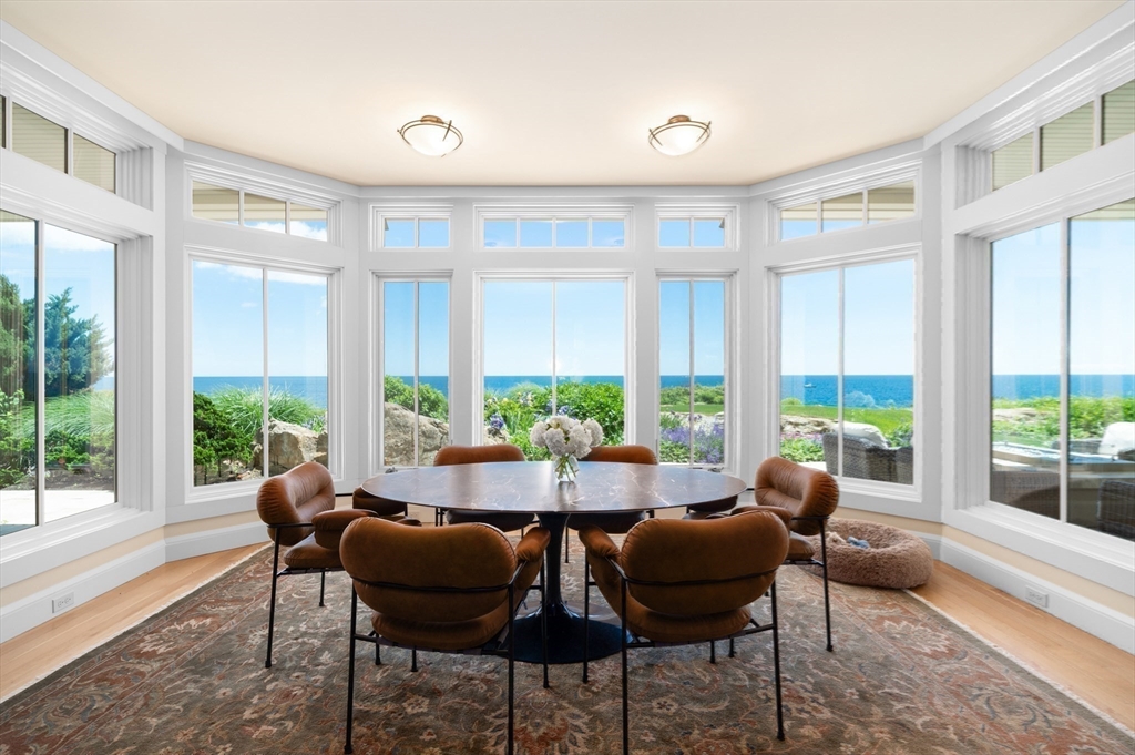 131 Atlantic Road Gloucester, MA 01930 - Photo 5 of 40 a view of a dining room with furniture large windows and wooden floor