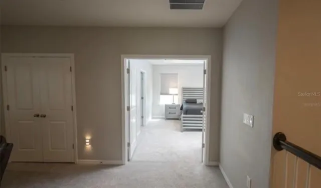 a view of a hallway with wooden shelves