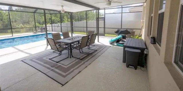 a living room with furniture and a floor to ceiling window