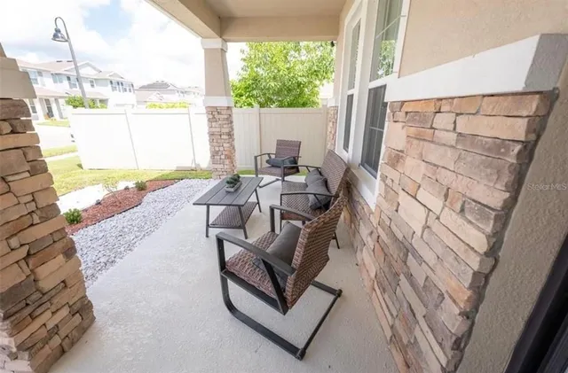 a living room with couch and a floor to ceiling window