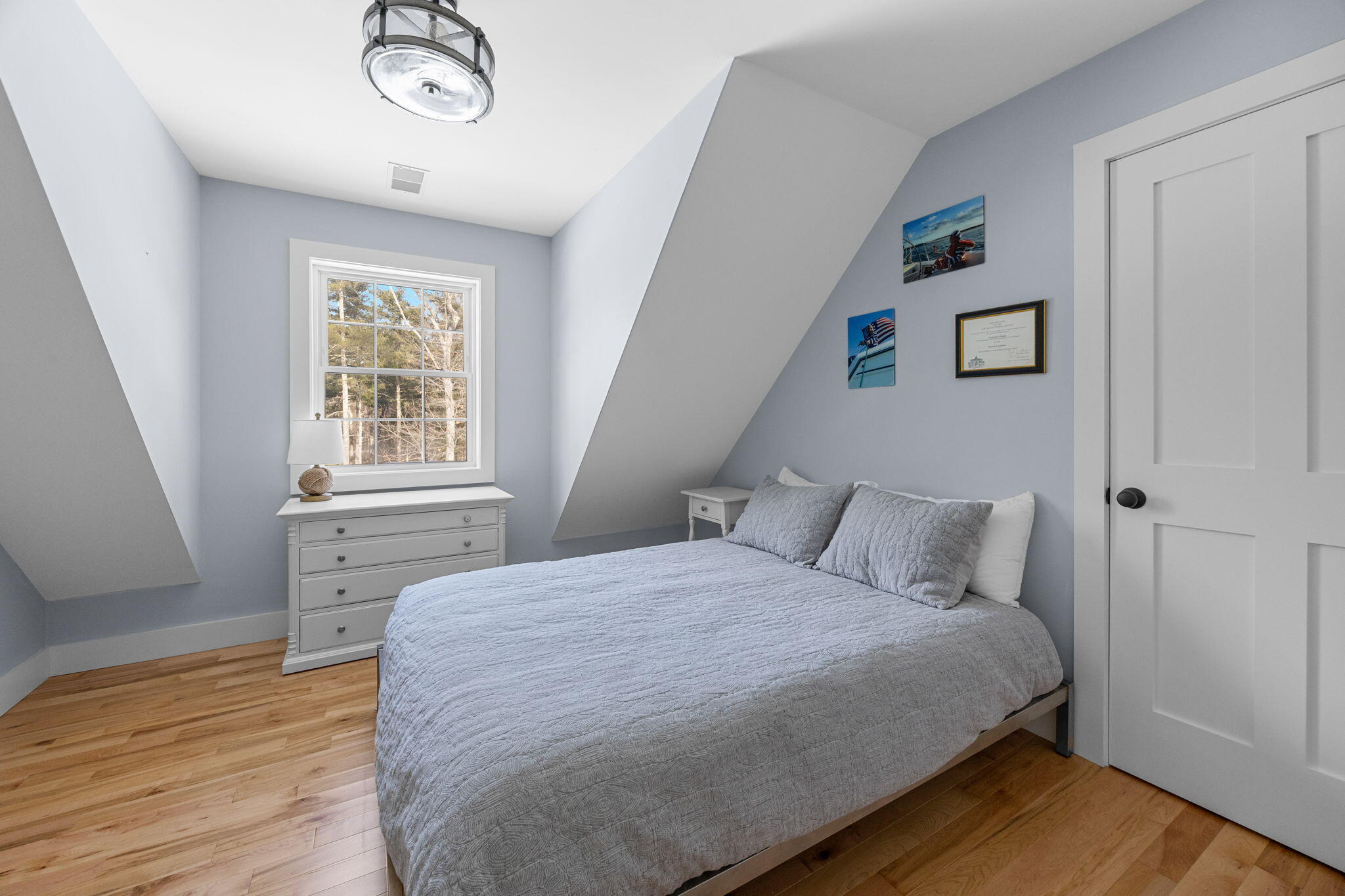 174 Cross Neck Road Marion, MA 02738 - Photo 27 of 41 a bedroom with a bed and wooden floor